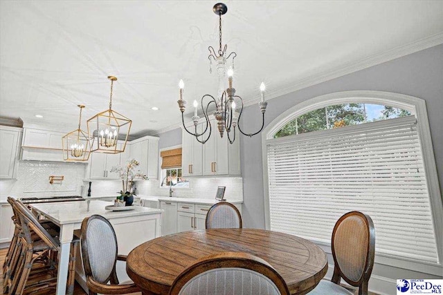 dining space with crown molding and a chandelier