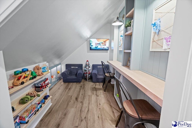 game room featuring lofted ceiling and light hardwood / wood-style flooring