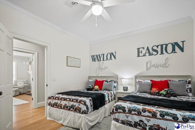 bedroom with crown molding, light hardwood / wood-style flooring, and ceiling fan