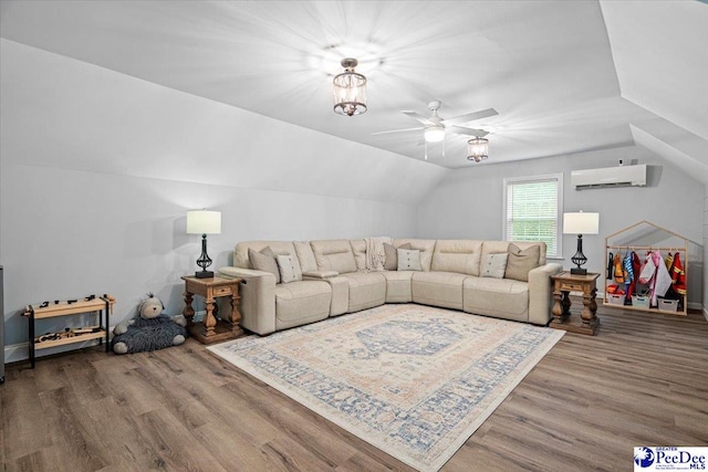 living room featuring lofted ceiling, hardwood / wood-style flooring, a wall unit AC, and ceiling fan