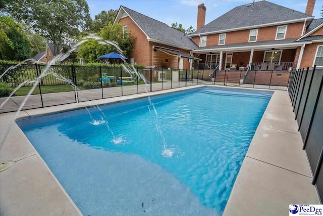 view of swimming pool featuring pool water feature and a patio area