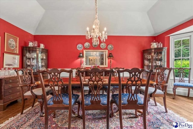 965 Scriven Dr, Flornce, SC 29501 - dining area with lofted ceiling, wood finished floors, and a chandelier