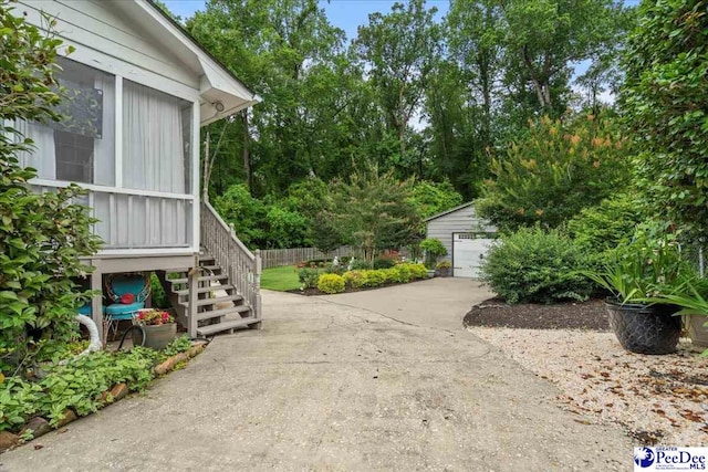 965 Scriven Dr, Flornce, SC 29501 - view of home's exterior featuring an outdoor structure, stairway, and a detached garage