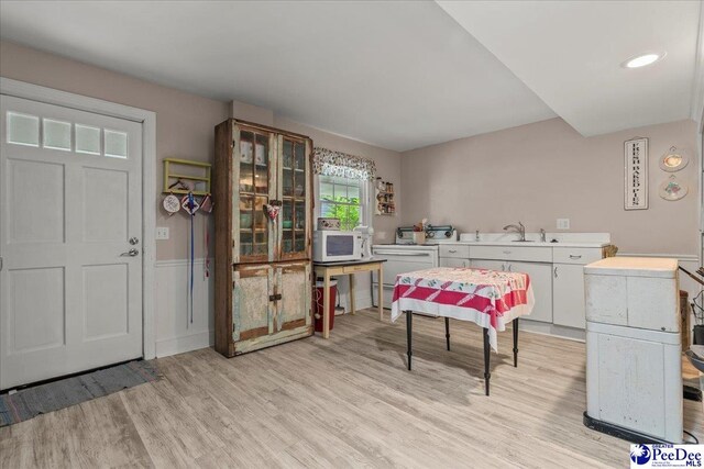 965 Scriven Dr, Flornce, SC 29501 - dining room with light wood-style floors and a wainscoted wall