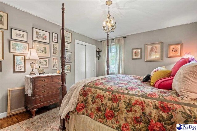 965 Scriven Dr, Flornce, SC 29501 - bedroom with wood finished floors, baseboards, a chandelier, and a closet