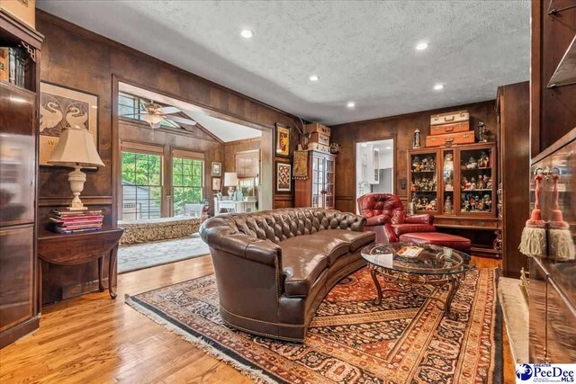 965 Scriven Dr, Flornce, SC 29501 - living room featuring wood walls, a textured ceiling, wood finished floors, ceiling fan, and recessed lighting
