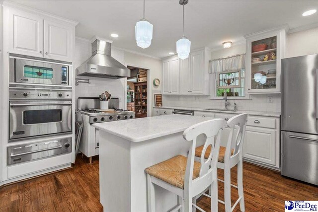 965 Scriven Dr, Flornce, SC 29501 - kitchen with appliances with stainless steel finishes, wall chimney range hood, a warming drawer, a sink, and decorative backsplash
