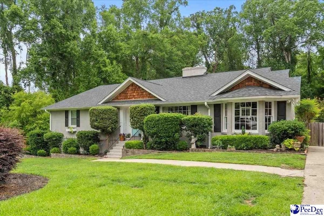 965 Scriven Dr, Flornce, SC 29501 - view of front facade with a chimney, a front lawn, and roof with shingles