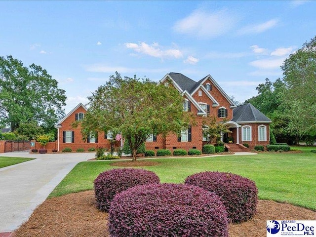 view of front of house featuring driveway, a front lawn, crawl space, and brick siding