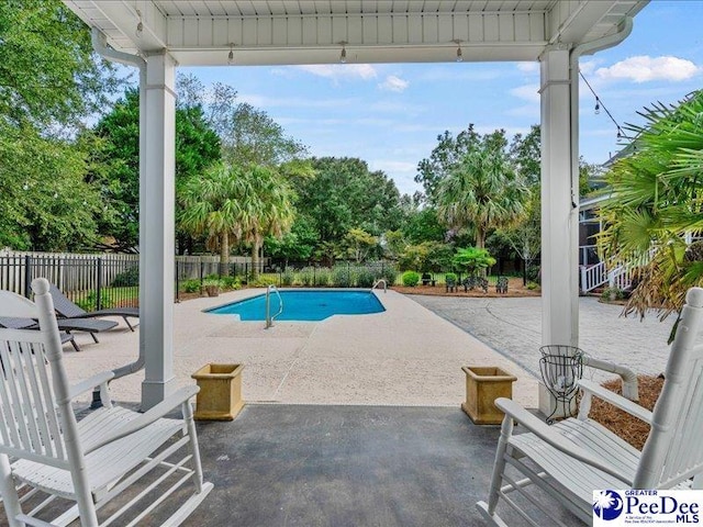 view of pool featuring a patio area, fence, and a fenced in pool