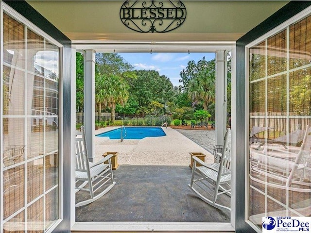 view of swimming pool featuring a patio and a fenced in pool