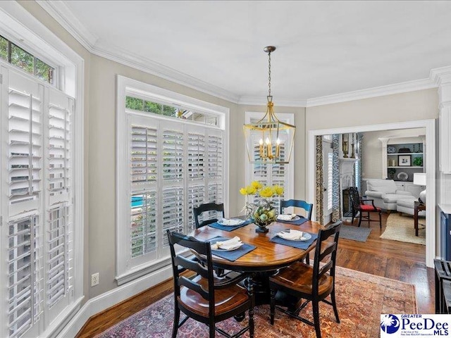 dining space with dark wood-style floors, crown molding, and a wealth of natural light