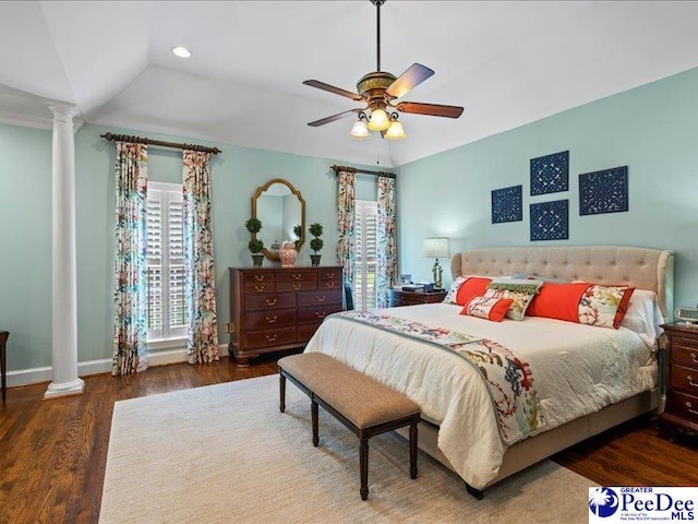 bedroom featuring vaulted ceiling, decorative columns, baseboards, and wood finished floors