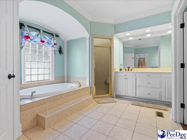 bathroom featuring tile patterned flooring, vanity, a bath, a stall shower, and crown molding