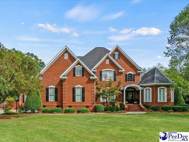 view of front of house with crawl space, brick siding, and a front lawn