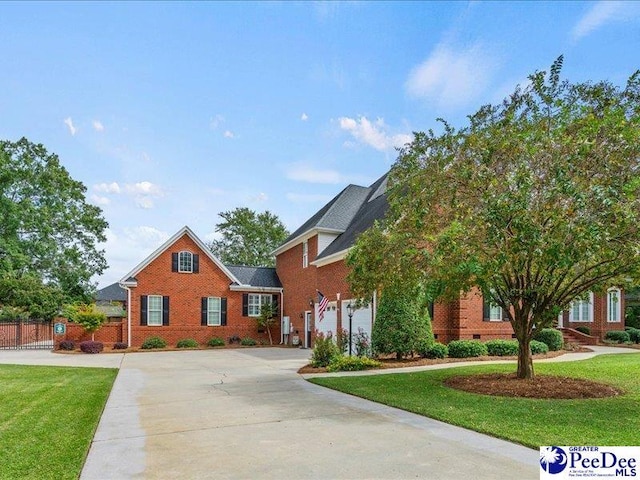 view of front of property with concrete driveway, a front lawn, crawl space, and brick siding