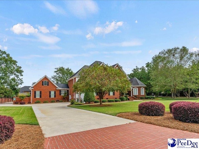 view of front of property with a garage, decorative driveway, and a front lawn