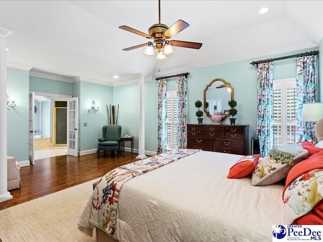 bedroom with french doors, crown molding, decorative columns, wood finished floors, and baseboards