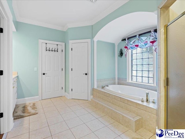 full bath featuring baseboards, tile patterned floors, a garden tub, crown molding, and a shower stall