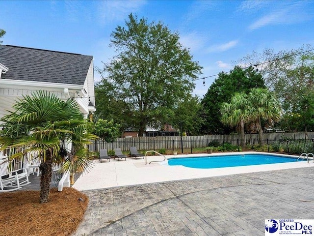 view of pool with a fenced in pool, a patio area, and fence