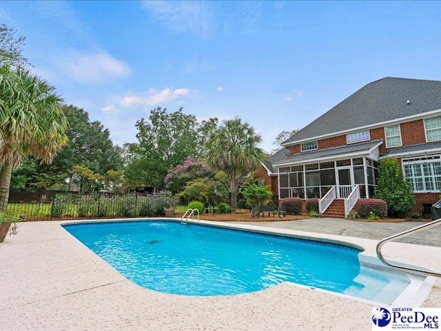 view of pool with a fenced in pool, a sunroom, fence, and a patio