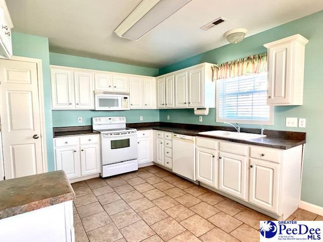 3014 Longfellow Dr, Florence, SC 29505 - kitchen with white appliances, sink, and white cabinets