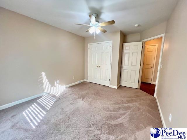 3014 Longfellow Dr, Florence, SC 29505 - unfurnished bedroom with a closet, ceiling fan, and carpet