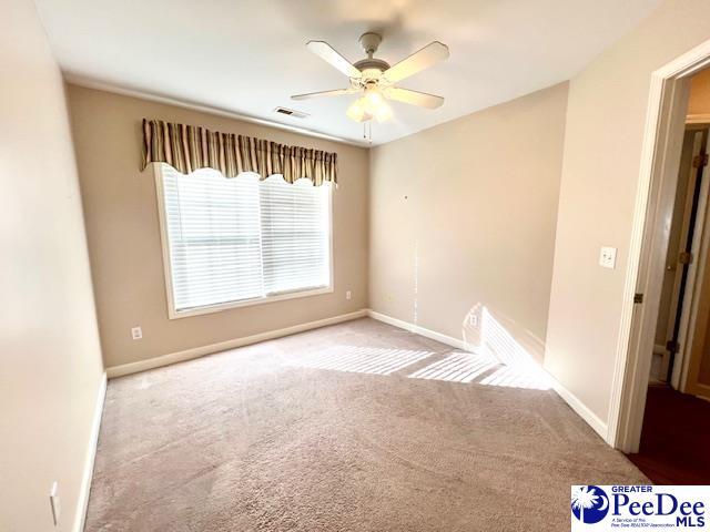 3014 Longfellow Dr, Florence, SC 29505 - unfurnished room with ceiling fan and light carpet
