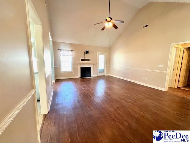 3014 Longfellow Dr, Florence, SC 29505 - unfurnished living room featuring high vaulted ceiling, dark hardwood / wood-style floors, and ceiling fan