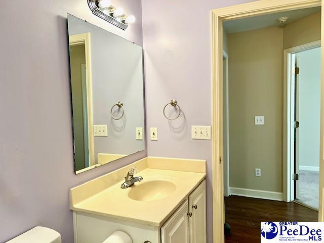 3014 Longfellow Dr, Florence, SC 29505 - bathroom with hardwood / wood-style flooring, vanity, and toilet