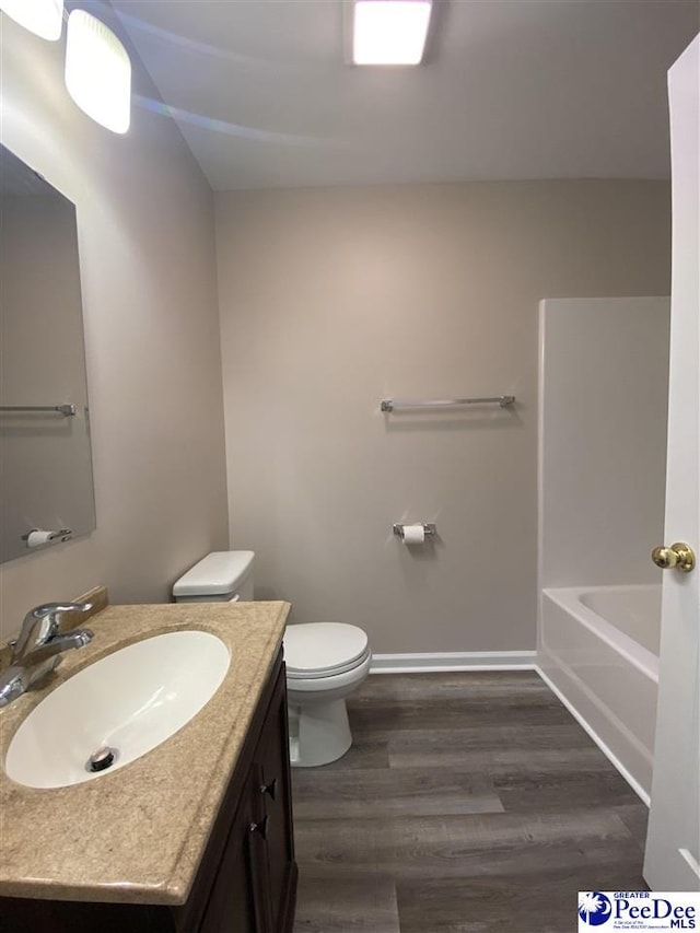 bathroom featuring vanity, hardwood / wood-style floors, and toilet