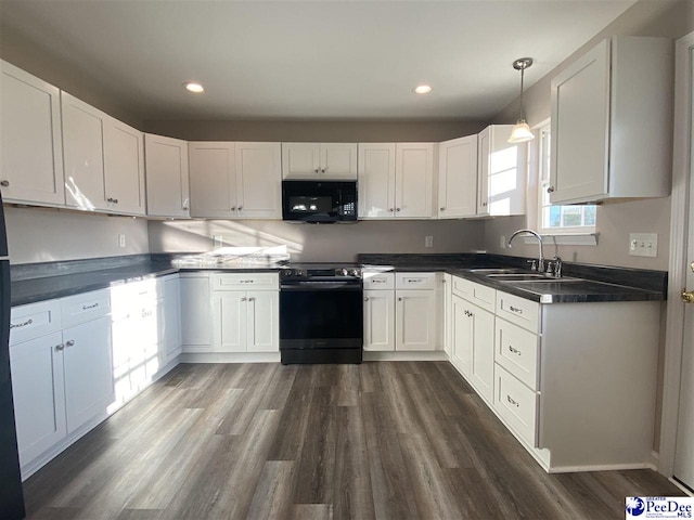 kitchen featuring decorative light fixtures, sink, white cabinets, and black appliances