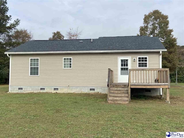 back of house featuring a wooden deck and a yard