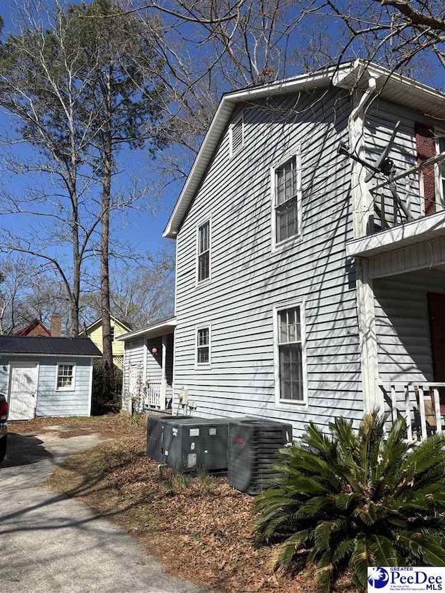 view of side of home featuring an outbuilding and central air condition unit