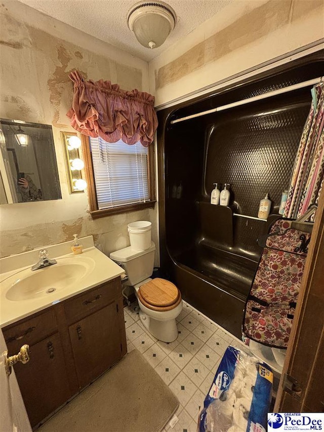 bathroom featuring tile patterned floors, a textured ceiling, vanity, and toilet