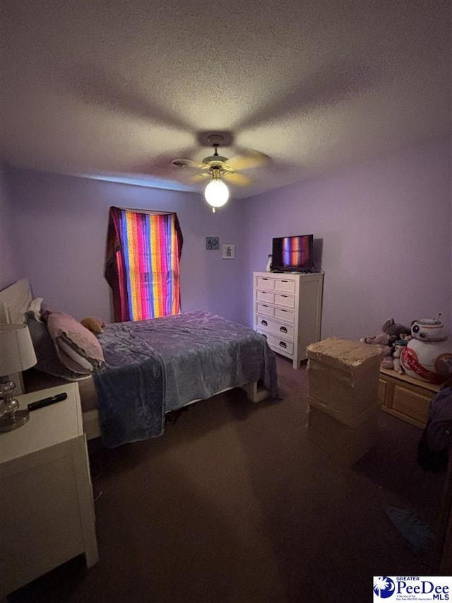 bedroom featuring a textured ceiling, ceiling fan, and carpet floors