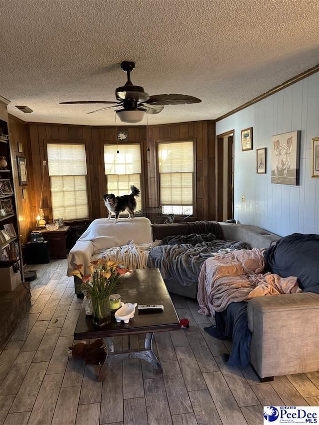 bedroom featuring ceiling fan, a textured ceiling, and wood finished floors