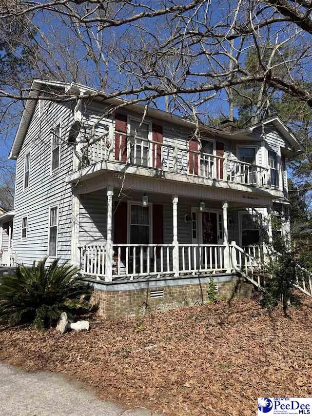 view of front of house with covered porch and a balcony