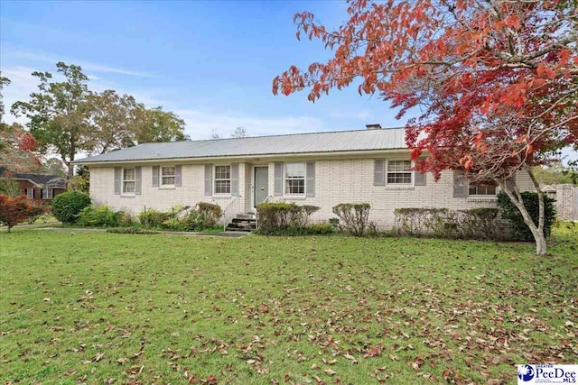 ranch-style house featuring a front lawn