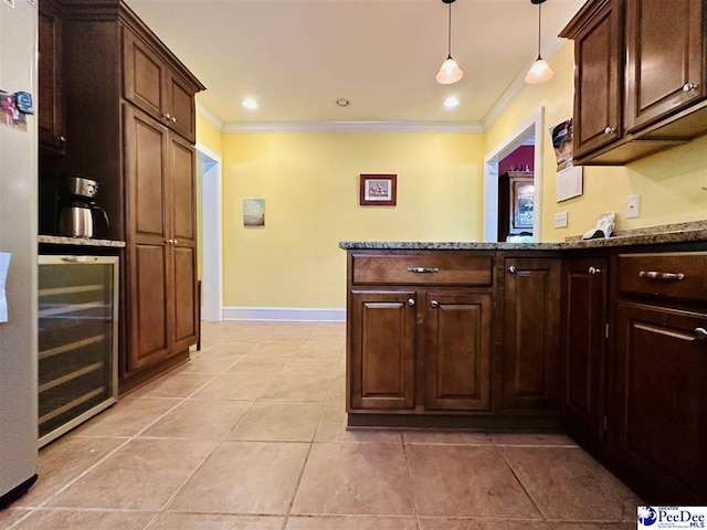 kitchen featuring ornamental molding, light stone countertops, pendant lighting, and wine cooler