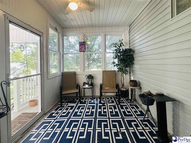 sunroom featuring wood ceiling and ceiling fan