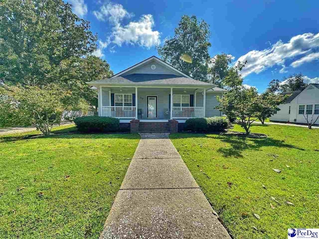 bungalow-style home with a front yard and covered porch