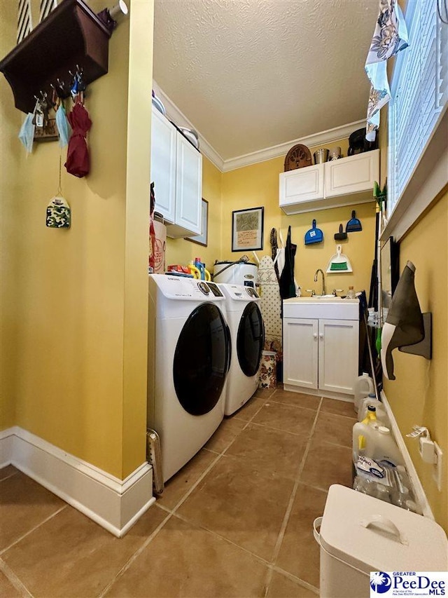 clothes washing area featuring independent washer and dryer, cabinets, tile patterned floors, and sink