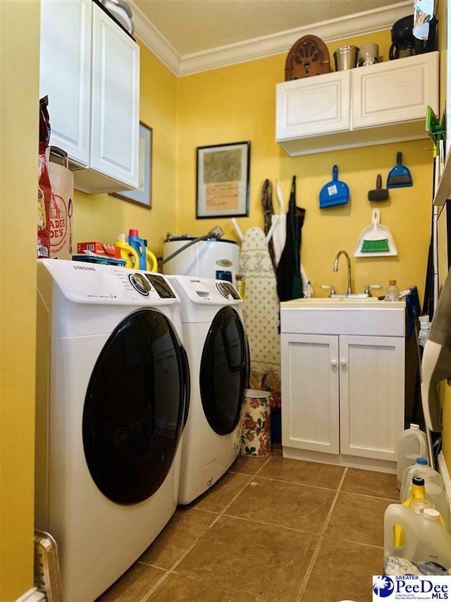 laundry area featuring sink, light tile patterned floors, cabinets, ornamental molding, and separate washer and dryer