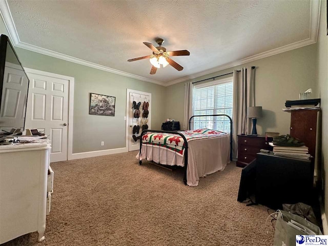 bedroom with ceiling fan, crown molding, a textured ceiling, and carpet flooring