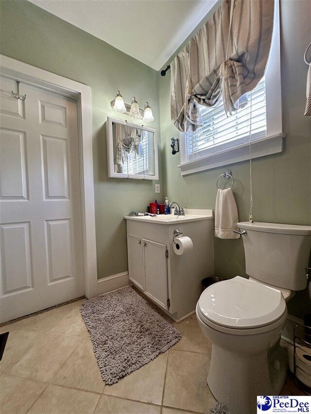 bathroom with vanity, tile patterned floors, and toilet