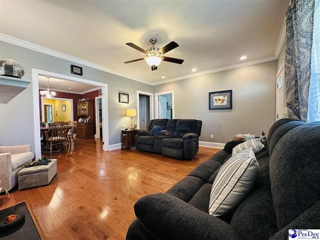 living room featuring crown molding, ceiling fan, and light hardwood / wood-style flooring