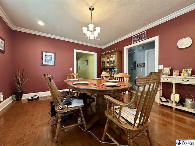 dining room with dark hardwood / wood-style flooring, a notable chandelier, crown molding, and a textured ceiling