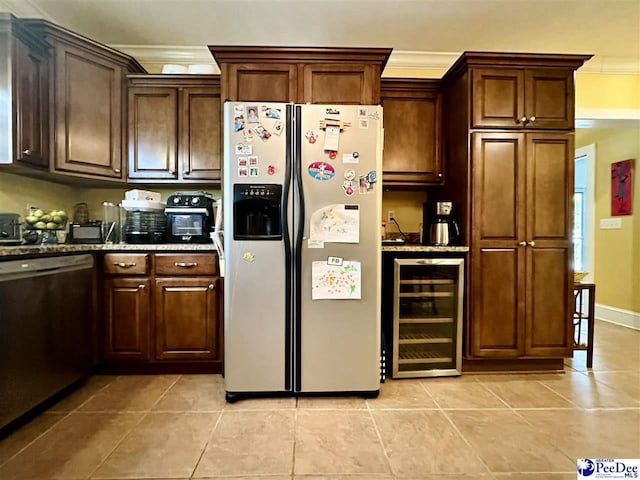 kitchen with appliances with stainless steel finishes, stone countertops, wine cooler, ornamental molding, and light tile patterned floors