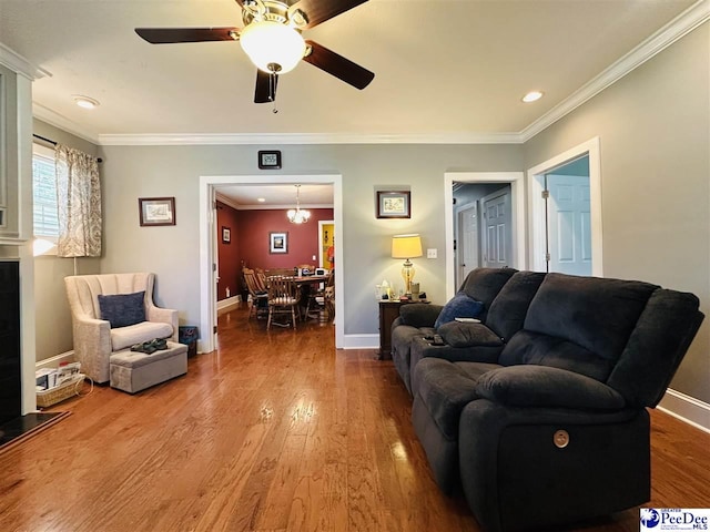 living room with crown molding, hardwood / wood-style flooring, and ceiling fan